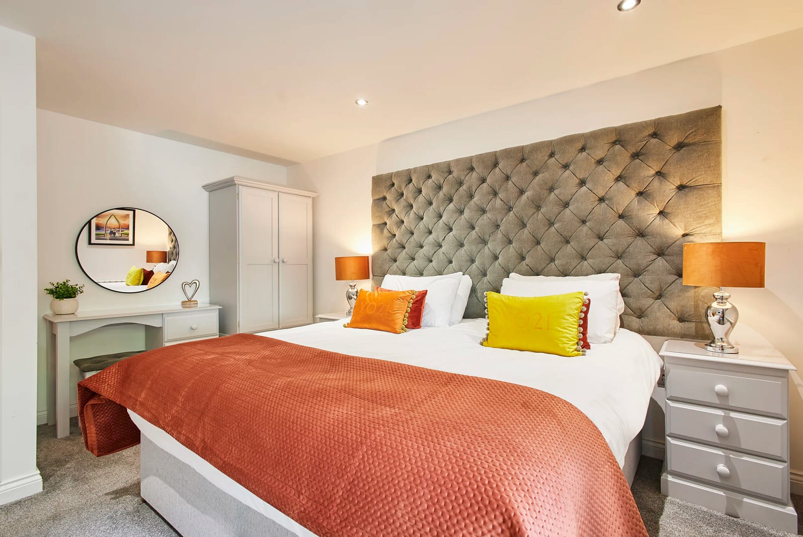 stay-north-yorkshire-number-one-carlill-whitby-28-hr 1 first bedroom boasts a luxurious super-king size bed dressed in crisp white linen, complemented by a calming blue colour scheme and a flat-screen TV