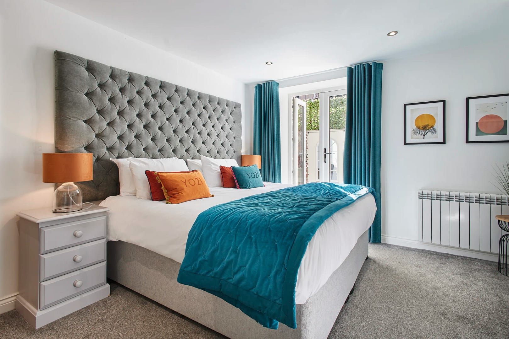 stay-north-yorkshire-number-one-carlill-whitby-44-hr 1 first bedroom boasts a luxurious super-king size bed dressed in crisp white linen, complemented by a calming blue colour scheme and a flat-screen TV
